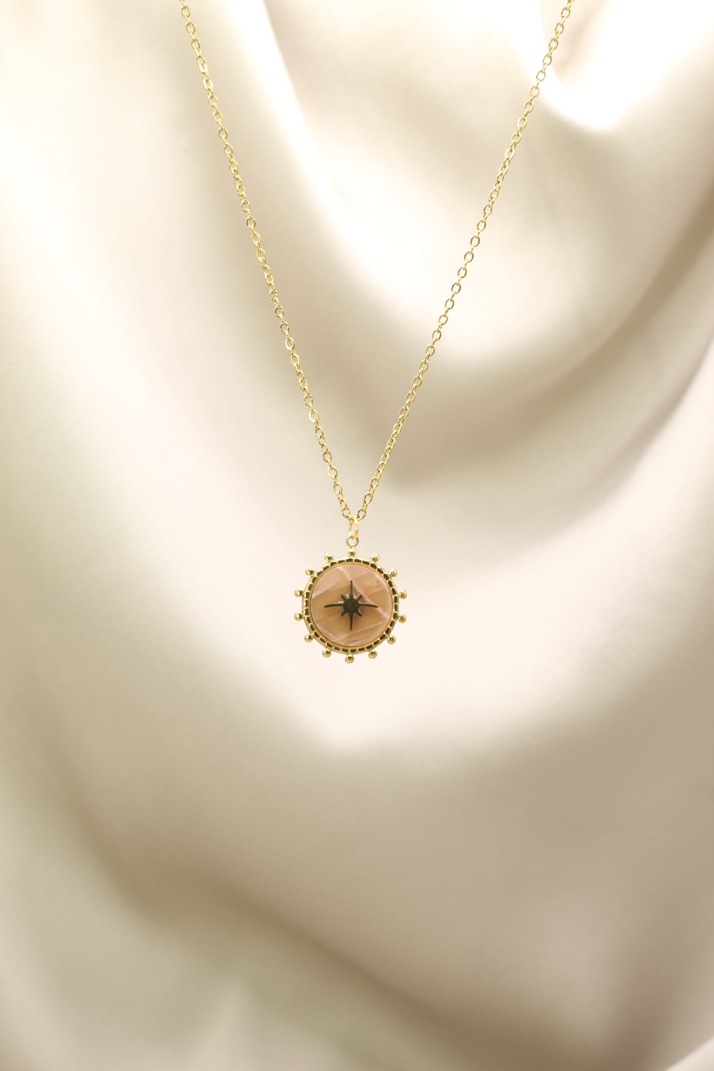 Necklace with a pendant on a beige background