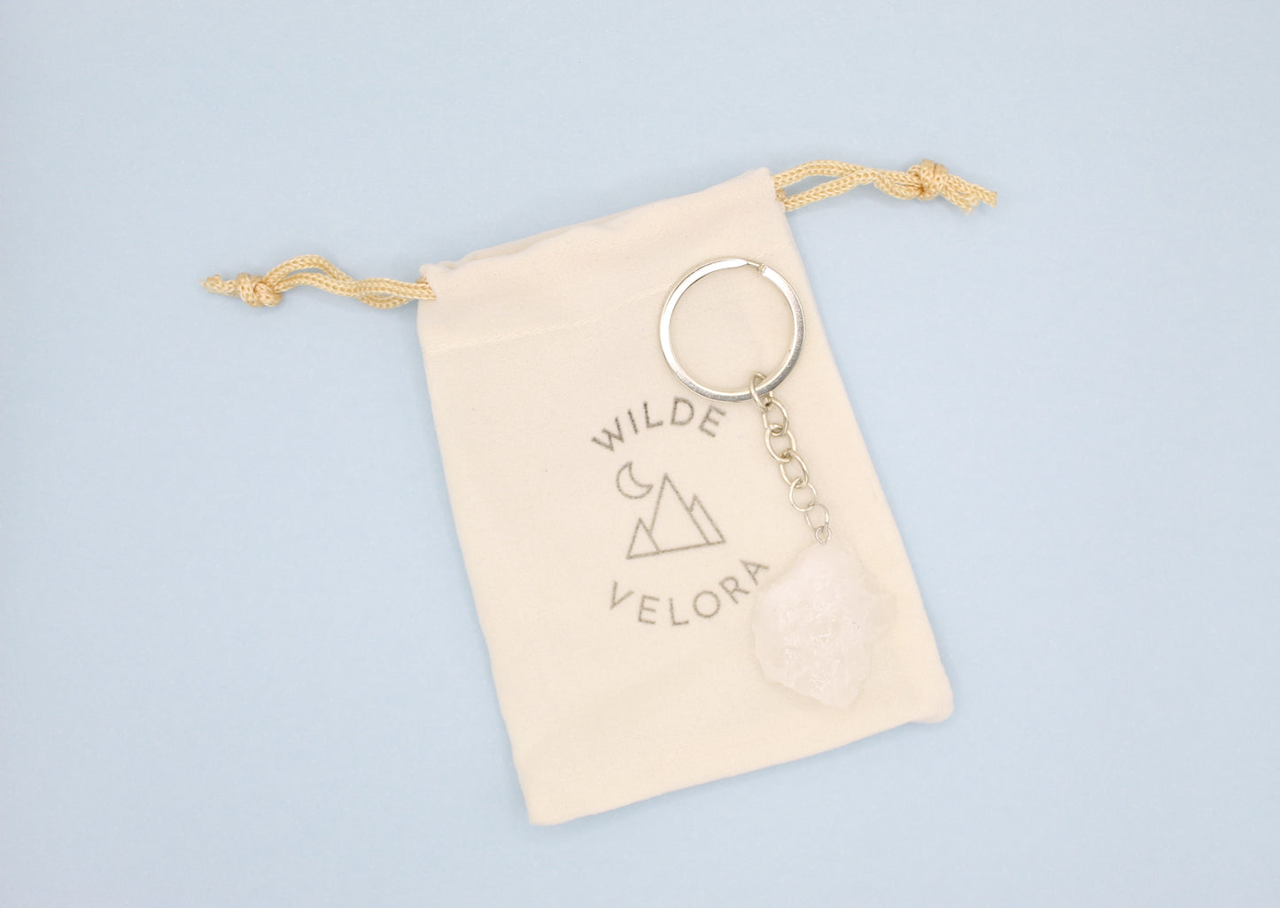 Keychain with 'Wilde Velora' branding on a light blue background