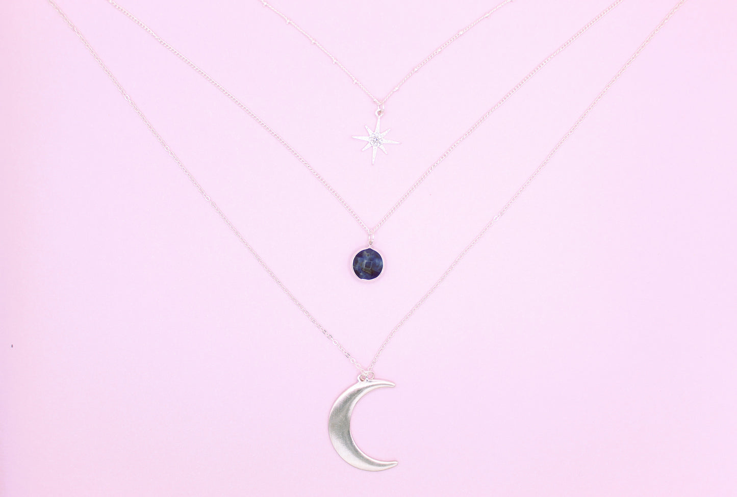 silver necklace with moon pendant and blue stone
