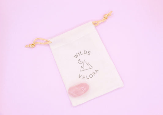 Wilde & Velora pouch with a pink heart on a light pink background