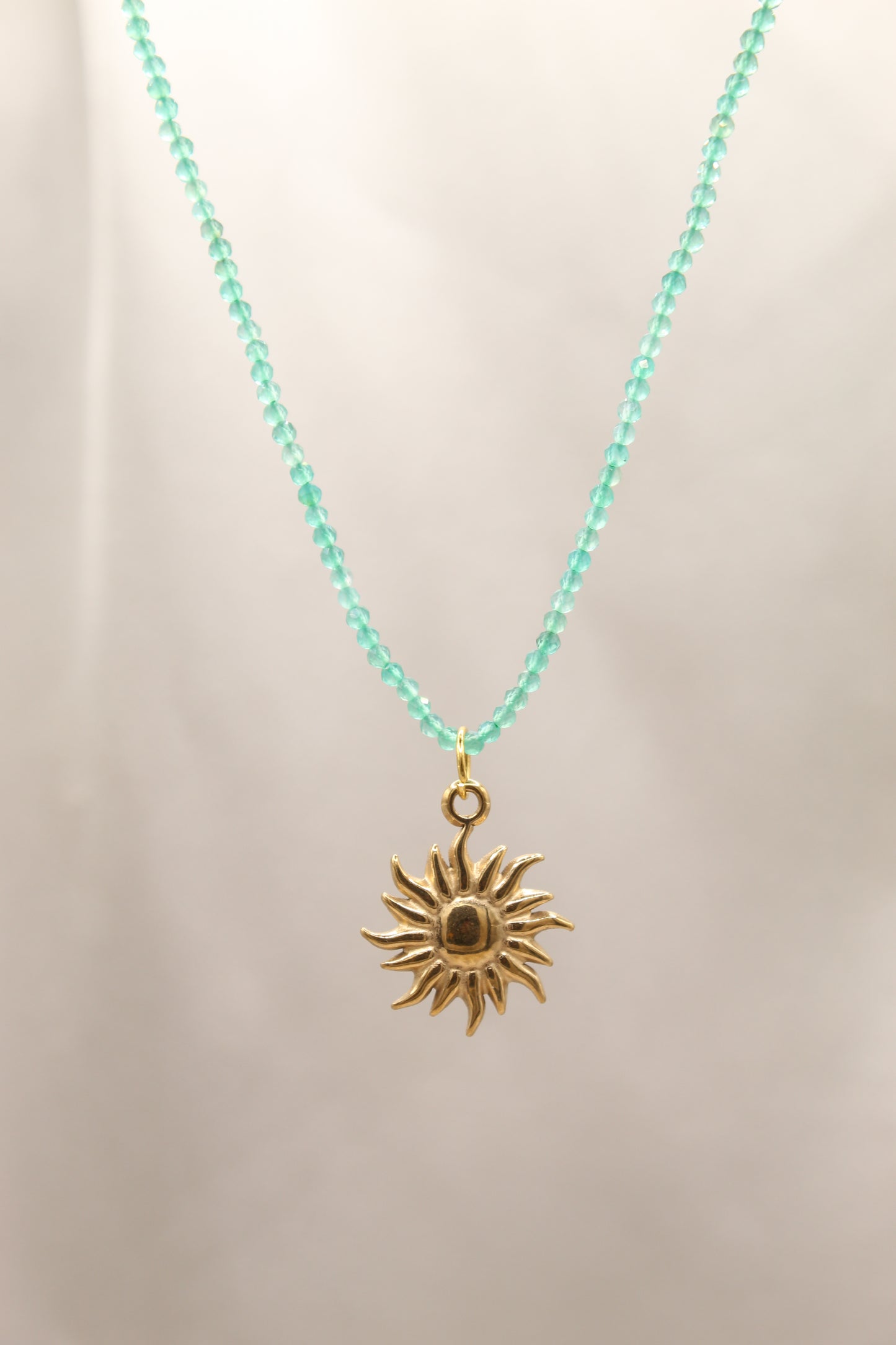Green aventurine beaded necklace with gold sun pendant