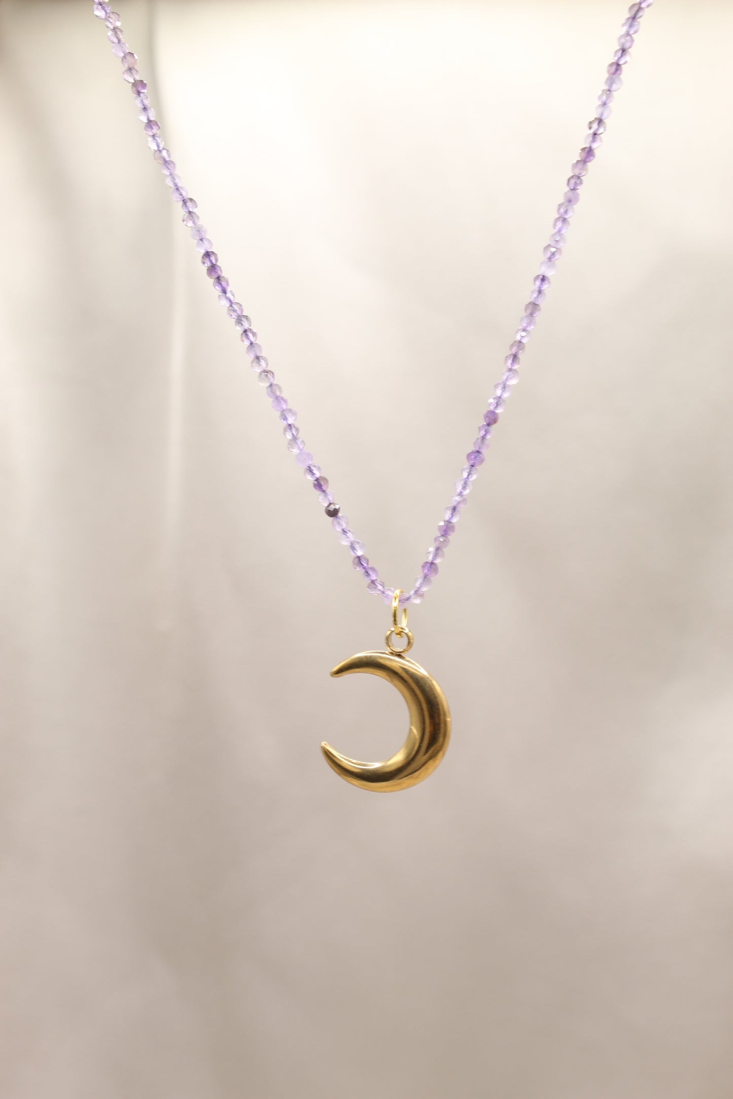 Amethyst beaded necklace with gold crescent moon pendant