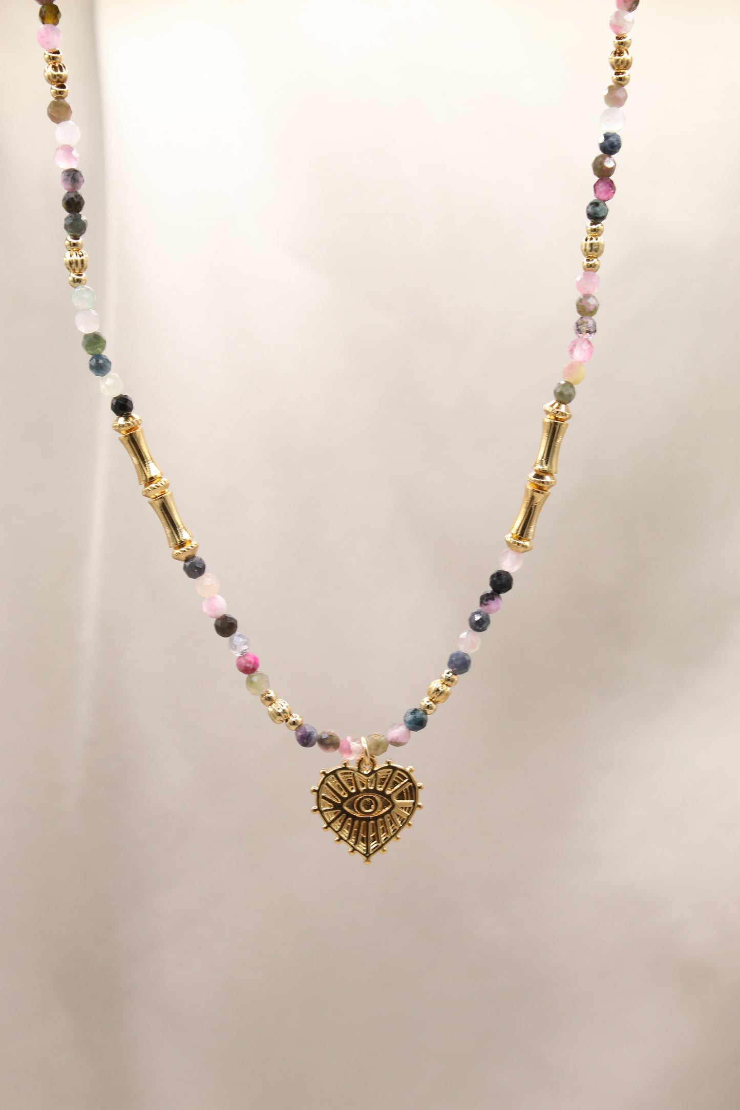 Tourmaline beaded necklace with gold eye heart pendant