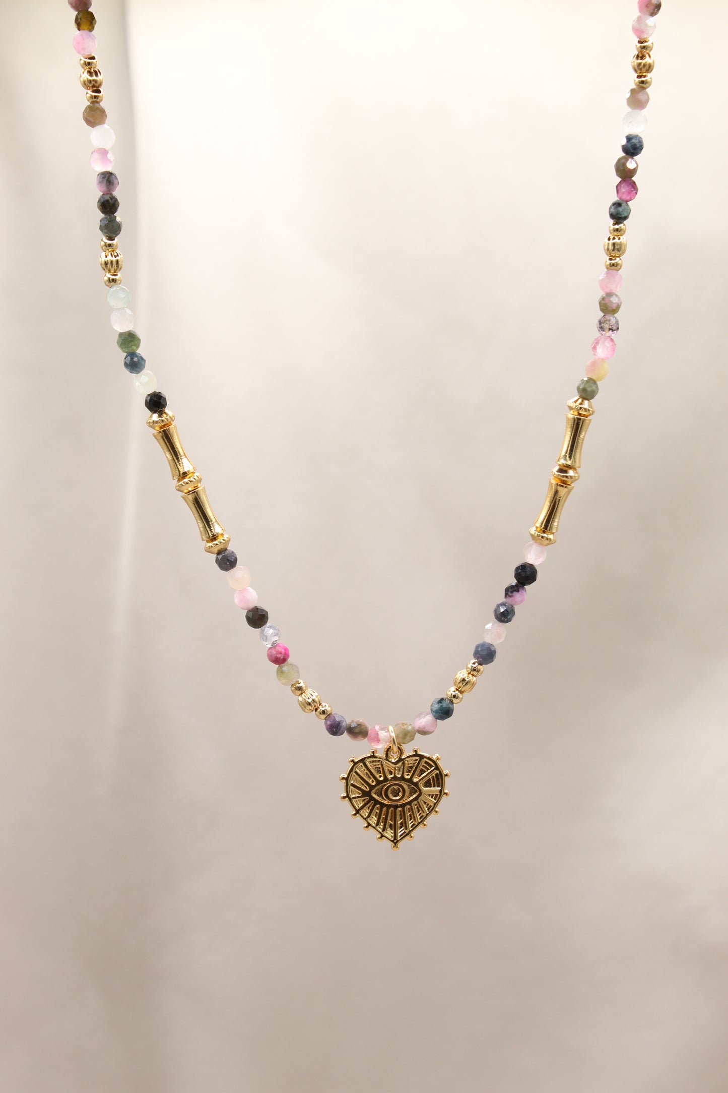 Tourmaline beaded necklace with gold eye heart pendant