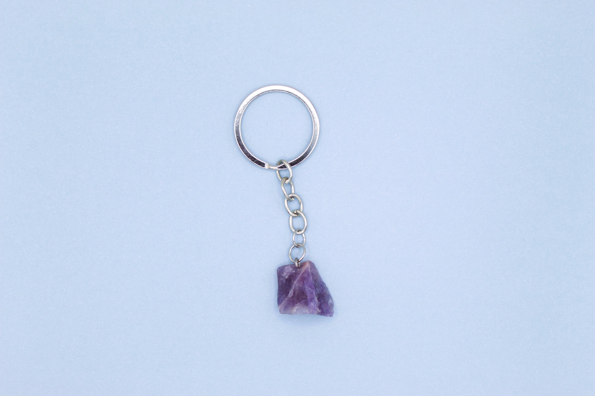 Keychain with a purple stone on a light blue background