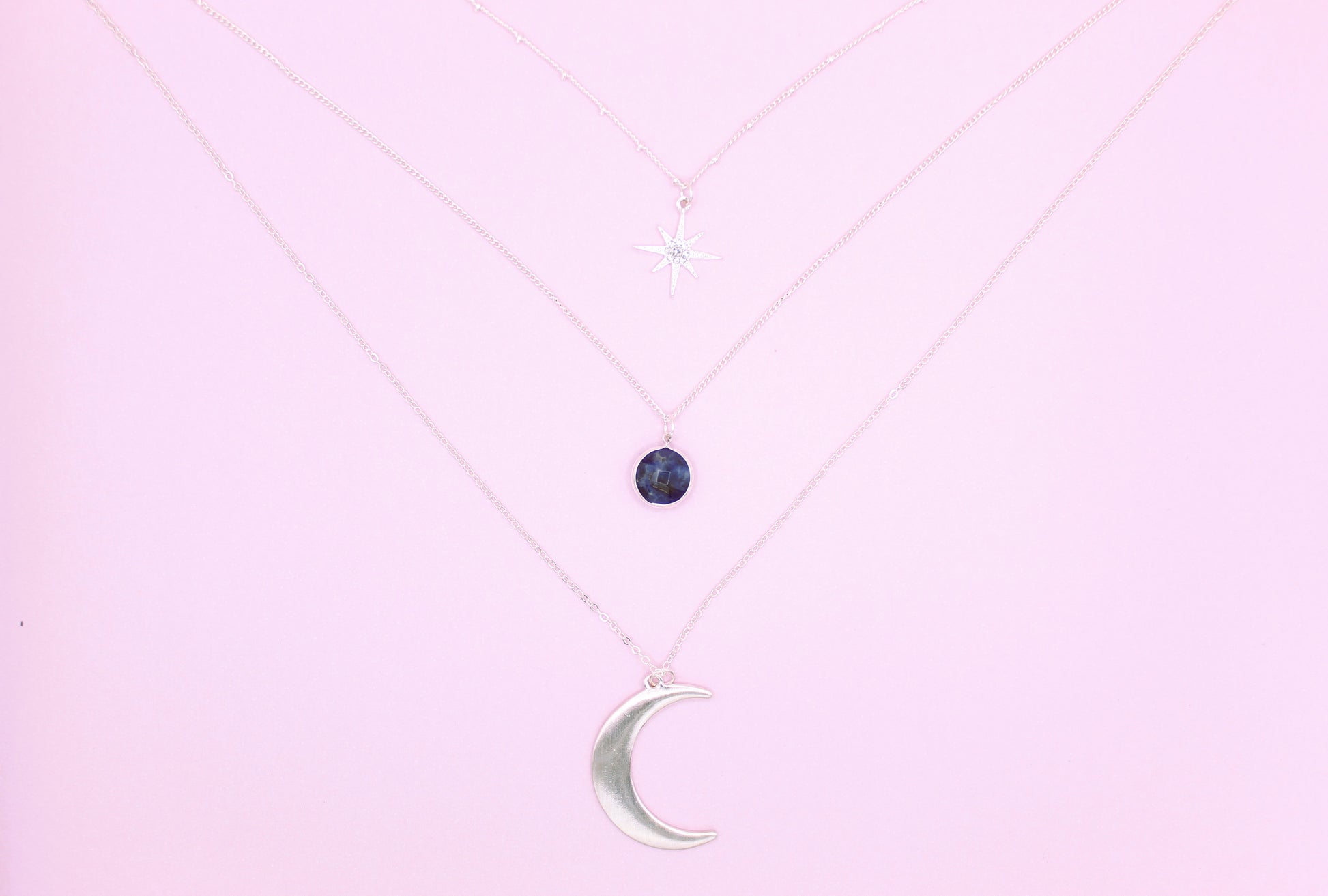 silver necklace with moon pendant and blue stone